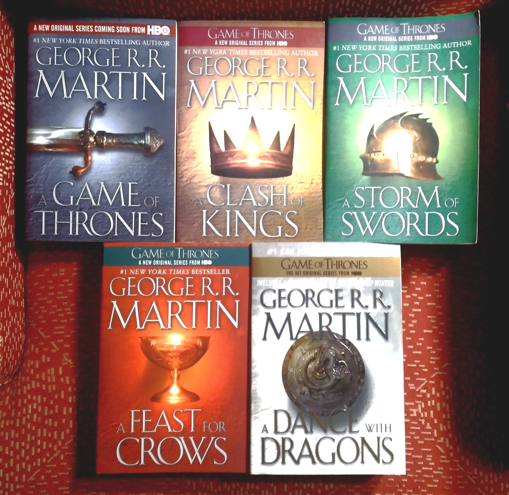 A lot of five (5) George R.R. Martin books from the Song of Fire and Ice series and tied in to the H.B.O. Series: A Game of Thrones; A Clash of Kings; A Storm of Swords; A Feast For Crows; A Dance With Dragons
