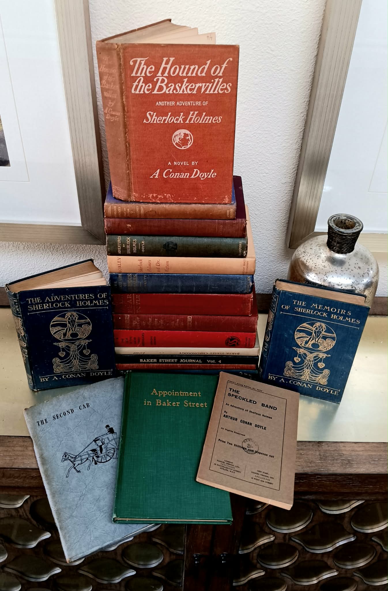 A lot of nineteen (19) books by and/or about Sir Arthur Conan Doyle, Sherlock Holmes and Dr. Watson: Ex Libris A. Conan Doyle; The Hound of the Baskervilles; The Adventures of Sherlock Holmes; The Last Adventures of Sherlock Holmes (cover says The Memoirs); The Life of Sir Arthur Conan Doyle; Sherlo
